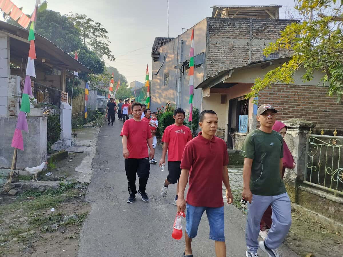 Warga Perumahan Kembang Harum 2 merayakan jalan sehat pada momentum HUT RI ke 80, pada Minggu (17/08/2025).